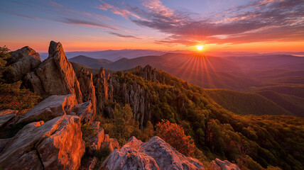 Golden sunrise illuminates a rocky mountain ridge with vibrant sky