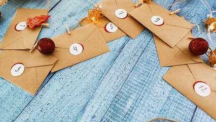 Preparing an Advent calendar for Christmas. Eco-craft envelopes with numbers for children. Christmas background, Advent from small craft envelopes.