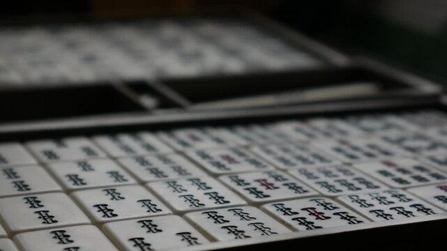 Traditional Mahjong Tiles Set with Circle Dots and Bamboo Sticks Arranged in Wooden Box