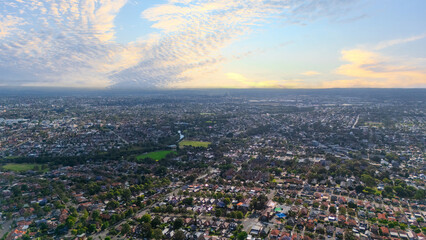 Panorama Sunset  aerial drone view of western Sydney Suburbs of Canterbury Burwood Ashfield Marrickville Campsie with Houses roads and parks in Sydney New South Wales NSW Australia