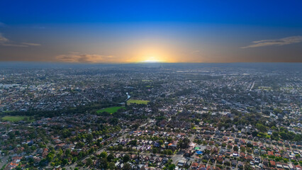 Panorama Sunset  aerial drone view of western Sydney Suburbs of Canterbury Burwood Ashfield Marrickville Campsie with Houses roads and parks in Sydney New South Wales NSW Australia
