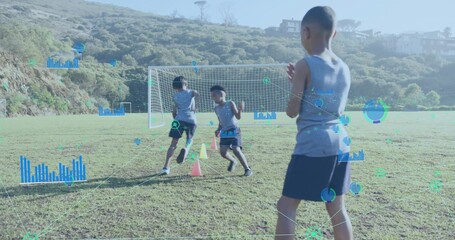Boy in training kit cheering on grass field, with goal net, neon cones, overlays, copy space
