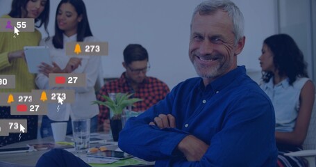 Smiling senior leader wearing shirt sitting at boardroom table, tablet digital alerts, copy space