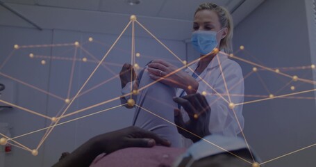 Doctor wearing white coat measuring patient waist with tape at clinic, with data map overlay