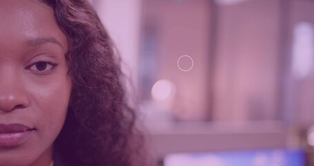Facing camera, woman in yellow top at desk, screen blur, pastel lights, copy space