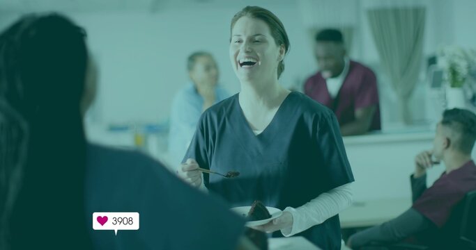 Laughing nurse holding plate with chocolate cake, fork in cafeteria, heart icon showing 3908 likes - Powered by Adobe