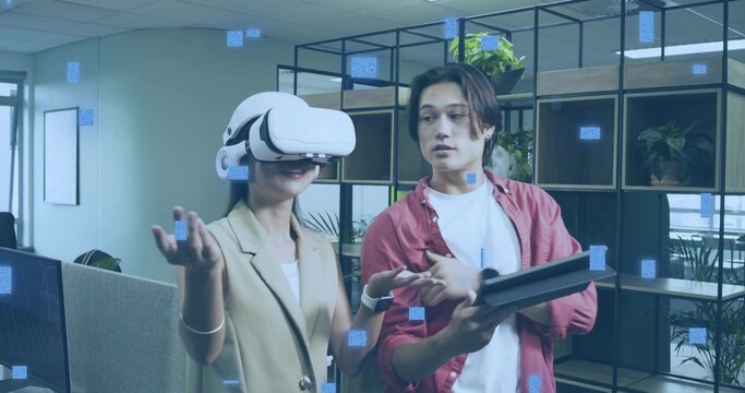 Testing coworkers in smart attire demonstrating virtual reality at office, VR headset and tablet