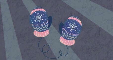 Displaying blue mittens with snowflakes and pink cuffs connecting by navy cord on lit gray surface