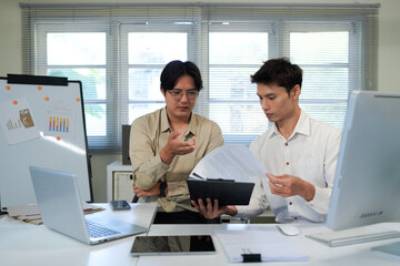Businessmen Discussing Over Document In Office