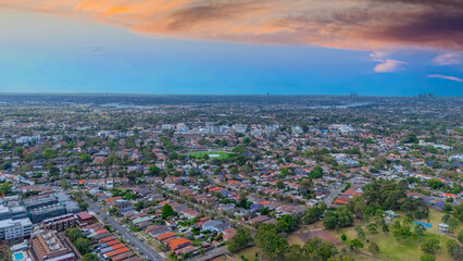Panorama Sunset  aerial drone view of western Sydney Suburbs of Canterbury Burwood Ashfield Marrickville Campsie with Houses roads and parks in Sydney New South Wales NSW Australia
