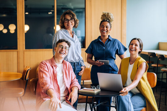 Happy group of coworkers enjoying teamwork in modern workplace