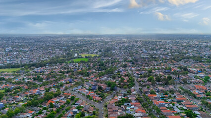 Panorama Sunset  aerial drone view of western Sydney Suburbs of Canterbury Burwood Ashfield Marrickville Campsie with Houses roads and parks in Sydney New South Wales NSW Australia