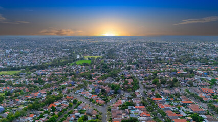 Panorama Sunset  aerial drone view of western Sydney Suburbs of Canterbury Burwood Ashfield Marrickville Campsie with Houses roads and parks in Sydney New South Wales NSW Australia