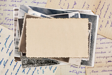 Stack old photos with blank copy space, lying on old letters. Abstract textured backdrop, postcard mockup.