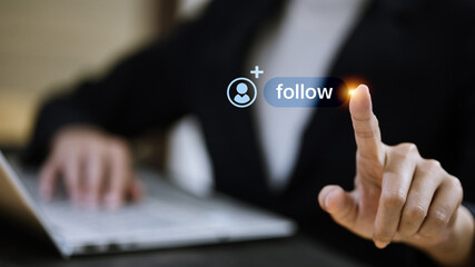 Business Professional Touching Virtual Follow Button Near Laptop