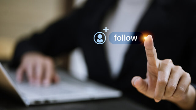 Business Professional Touching Virtual Follow Button Near Laptop