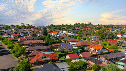 Panorama Sunset  aerial drone view of western Sydney Suburbs of Canterbury Burwood Ashfield Marrickville Campsie with Houses roads and parks in Sydney New South Wales NSW Australia