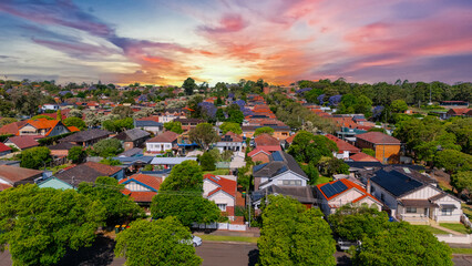 Panorama Sunset  aerial drone view of western Sydney Suburbs of Canterbury Burwood Ashfield Marrickville Campsie with Houses roads and parks in Sydney New South Wales NSW Australia
