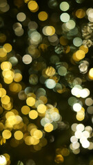 Defocused string lights on christmas tree, shiny gold yellow blurred bokeh circle background wallpaper for festive season celebration. 
