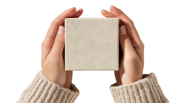 Hands holding a textured cube with a natural pattern, isolated on transparent background