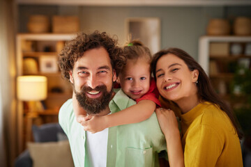 Family members share a joyful moment in their cozy living room, filled with laughter and smiles, enjoying quality time together and creating lasting memories.