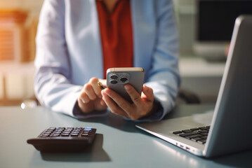 Businesswoman using a stylus with smart phone in office. Concept of smart technology, remote work