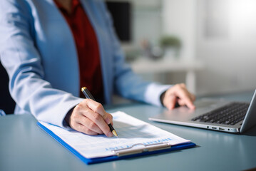 Professional managing reports and smartphone tasks in modern office, symbolizing business communication, data management, and productivity.