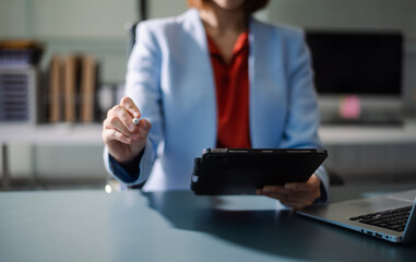 Professional using digital tablet in modern office, symbolizing technology, innovation, productivity, and teamwork in business communication and digital workflow.