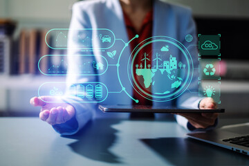 Woman using futuristic interface with smart tech and mobile to manage ESG, clean energy, and sustainability data.