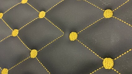 Obraz premium Luxurious black leather with golden stitching creates an elegant modern texture for high end design projects