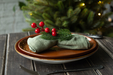 Christmas table setting. Plate with napkin decorated for Christmas dinner.