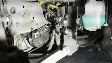 car oil filter. car without wheel, windshield washer fluid, fuel filter replacement. close-up, night light