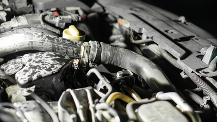 car under the hood, pipes and parts. station wagon. close-up, night light