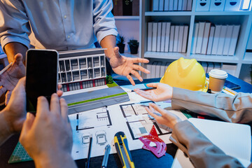 A diverse team of professionals shares ideas about architectural layouts and structural concepts, focusing on teamwork, creativity, and precision in modern engineering design discussions.