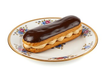 Delicious chocolate eclair pastry on decorated plate isolated on white