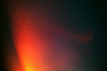 light leak overlay effect with blur red light leaks,retro noisy film texture light leak flare on black background,grunge old film burn texture with ray,abstract background with orange bright light © ZMC-Studio