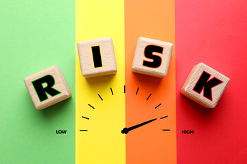 Risk word made of wooden cubes and scale on colorful background, top view