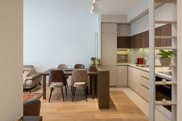 Stylish modern apartment with open kitchen and warm dining area
