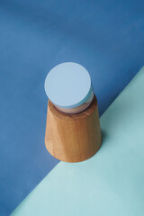 A Wardah powder compact is placed on a blend of dark blue and light blue background, creating a soft yet elegant contrast