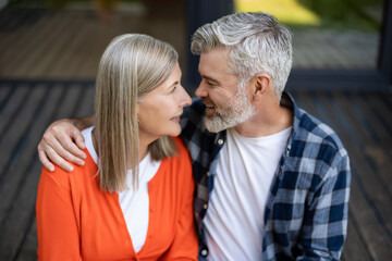Man and woman sitting together hugging and feeling in love