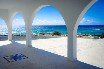 View of the sea and the coast from the arches of a greek chapel