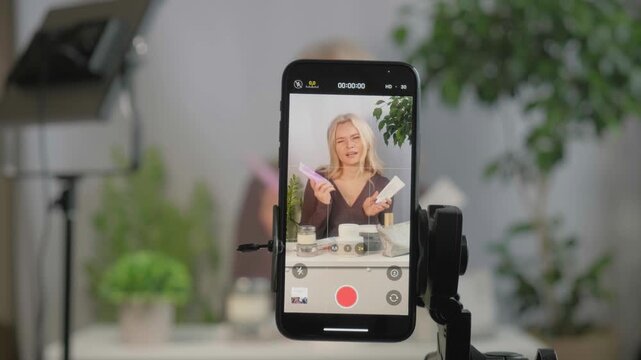 Face, makeup influencer or vlog with girl, spray or advice with content creator, promotion for cosmetics product or live streaming. Portrait, person or woman with item for skincare or record tutorial