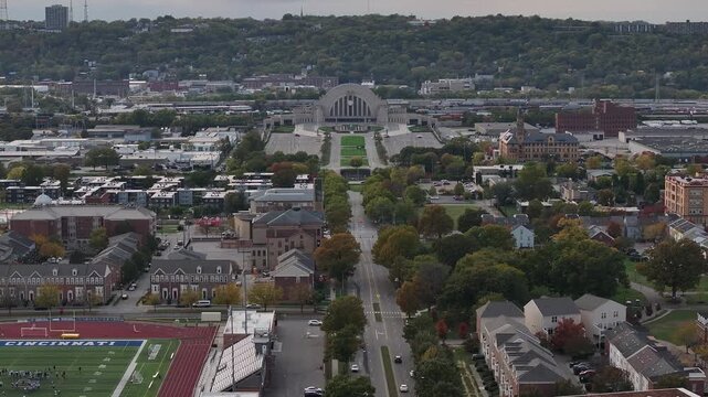 Aerial view of Union Terminal, surrounded by buildings and trees, showcasing urban architecture and lush greenery from above, Cincinnati, Ohio, United States.