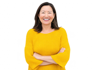 Smiling middle aged Asian woman in yellow sweater with arms crossed, standing confidently against transparency background, expressing happiness and positivity