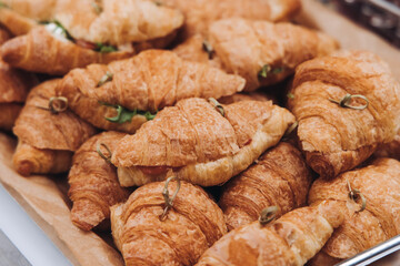 Set of coffee break in the hotel during conference meeting, with tea and coffee catering, decorated catering banquet table with variety of different pastry and bakery, with croissants, pie and cookies