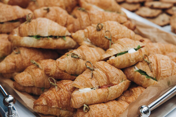 Set of coffee break in the hotel during conference meeting, with tea and coffee catering, decorated catering banquet table with variety of different pastry and bakery, with croissants, pie and cookies