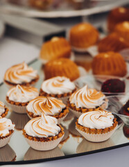 Set of coffee break in the hotel during conference meeting, with tea and coffee catering, decorated catering banquet table with variety of different pastry and bakery, with croissants, pie and cookies
