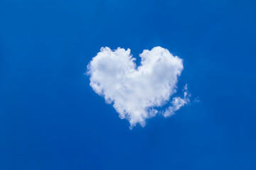 White soft cloud with heart shaped shown on clear blue sky and sunshine day. Background for greeting cards or love picture theme - Valentine&rsquo;s Day or meteorology representation or inspiration concept.