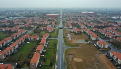Fototapeta premium Aerial view suburban area with rows of houses and road. Residential district with red roofs buildings. Infrastructure neighborhood with green lawns. Urban cityscape environment planning.