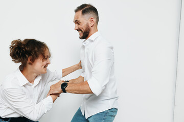 Obraz premium Businessman in a white shirt stands with a colleague against a pure white background, exuding confidence, focus, and positive energy in a professional setting.